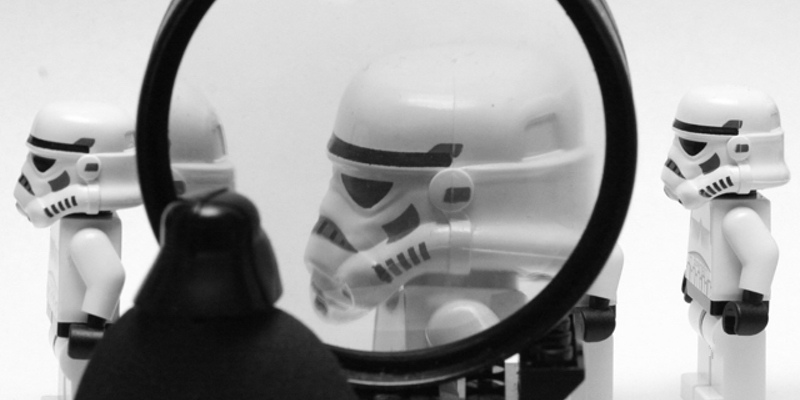 picture of Lego Darth Vader inspecting a storm trooper with a magnifying glass